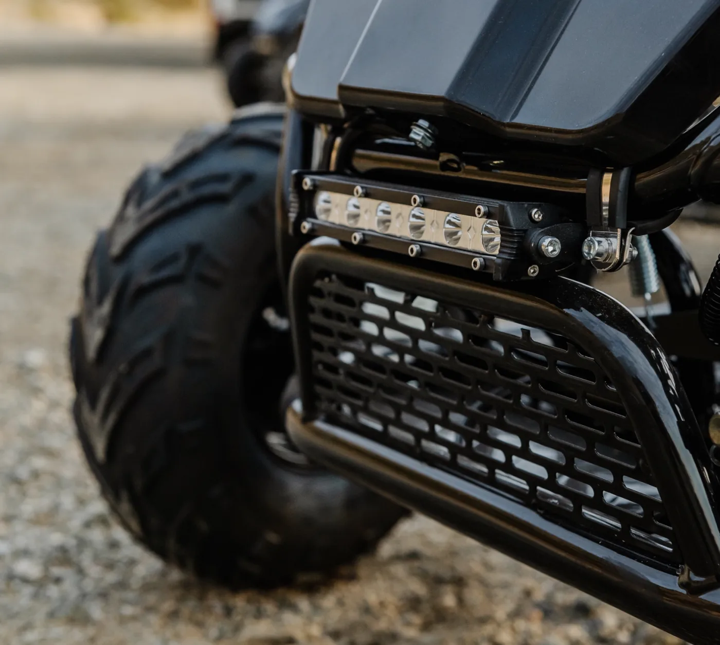 Macro close-up of a go-kart's front grille, LED light bar and tire