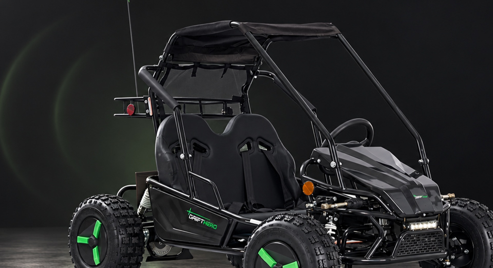 Electric two-seat go-kart in a dark studio